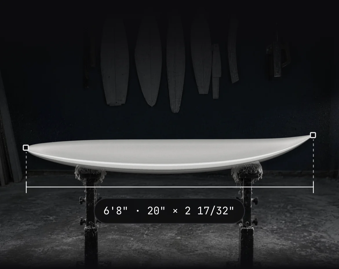 A finished board on shaping stands with its length measured