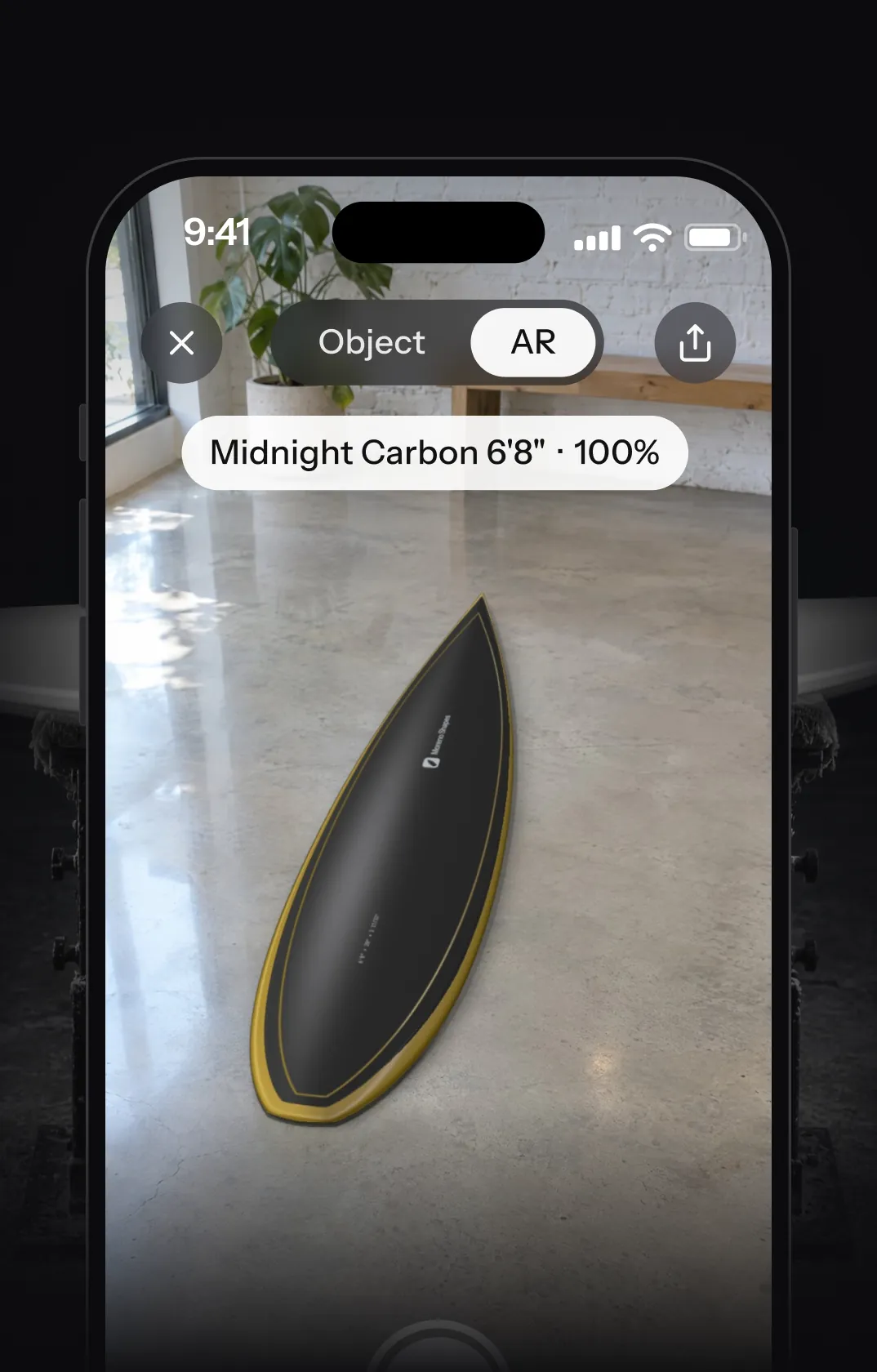 An iPhone placing Midnight Carbon 6'8" in a room with AR Quick Look, in a dark shaping bay